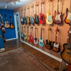 The Guitar Lounge - Wall full of custom shop electric guitars from Fowlcon Guitar Company
