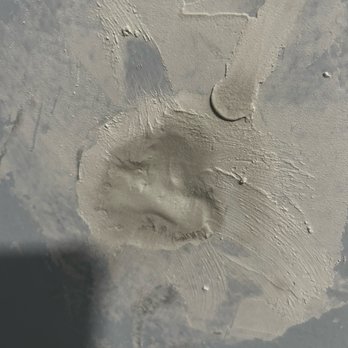 Webb Home Remodeling - Hole packed full of mud instead of being repaired properly with a patch. - General Contractors Near Me Webb Home Remodeling - Hole packed full of mud instead of being repaired properly with a patch. - General Contractors Near Me