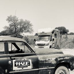 a black and white photo of a truck and a bus