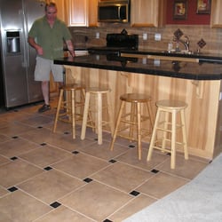 Tile Tech - Me putting final touches on the Black Galaxy granite tile counter tops. Notice the pin-wheels in the back splash. Maintenance free epoxy.