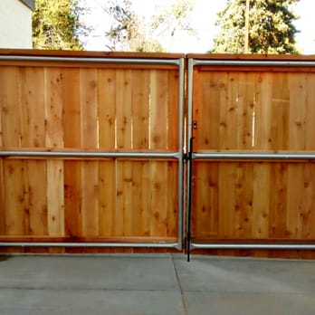 Denver Fence Construction - Double drive gate strengthened by metal posts - Fences & Gates Near Me - Denver, Colorado Denver Fence Construction - Double drive gate strengthened by metal posts - Fences & Gates Near Me - Denver, Colorado
