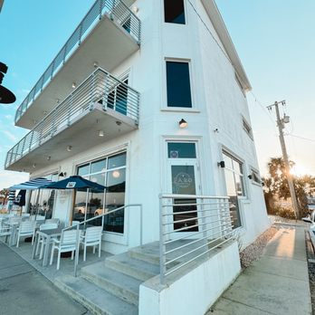 Faro - a view of a white building with a balcony - Pizza Near Me - Flagler Beach, Florida