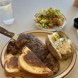 Almo Inn & the Outpost Steakhouse - 12oz medium rare ribeye steak and baked potato cooked to perfection