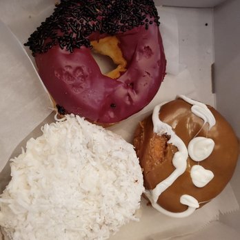 Voodoo Doughnut - Vicious Hibiscus on top, guava colada on the left, maple cream on the right - Donuts Near Me - Austin, Texas