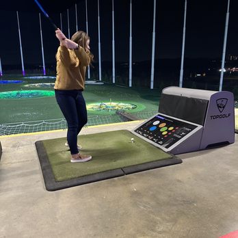 Topgolf - Player swinging - Golf Near Me - Fort Myers, Florida Topgolf - Player swinging - Golf Near Me - Fort Myers, Florida