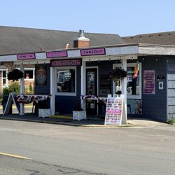Front of the restaurant showing the bar stools and counter table for outdoor seating