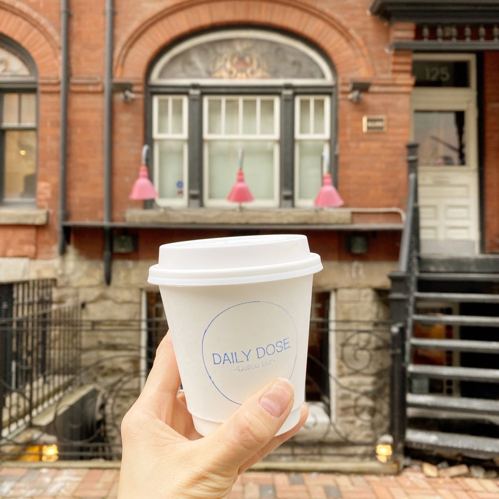 Daily Dose Coffee Bar - a hand holding a cup of coffee - Coffee & Tea Near Me - Toronto, Ontario