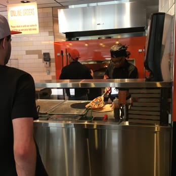 Blaze Pizza - Taking the pizza out of the blazing hot oven - Pizza Near Me - Cambridge, Massachusetts