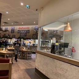 You can watch the chefs work cutting vegetables, preparing dough, behind this big glass wall