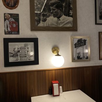 Milkman - View of the wall next to the booth which features fun photos. Additionally, each booth has its own light. - Burgers Near Me - Cincinnati, Ohio Milkman - View of the wall next to the booth which features fun photos. Additionally, each booth has its own light. - Burgers Near Me - Cincinnati, Ohio