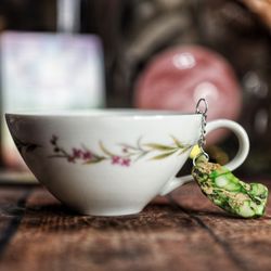 Manifestation Makers - Sip intention with every brew. Tea infuser adorned with a crystal charm for energy & mindfulness.
