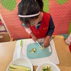 Brilliant Kids+ Childcare & Preschool - Cutting zucchini for lunch