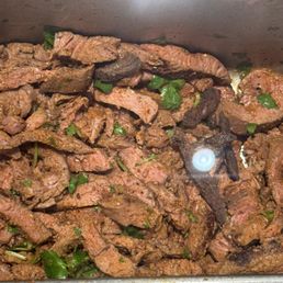 Those tiny black pieces we really added after he put the fresh asada on the line. I had to request he not put those in our burritos.