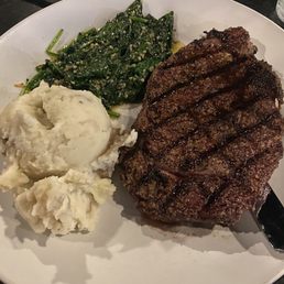 12 oz CAB Ribeye with garlic sautéed spinach and mashed potatoes