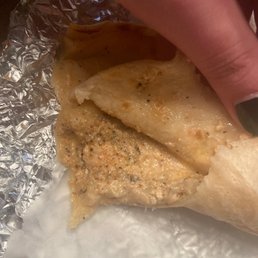 a hand holding a tortilla