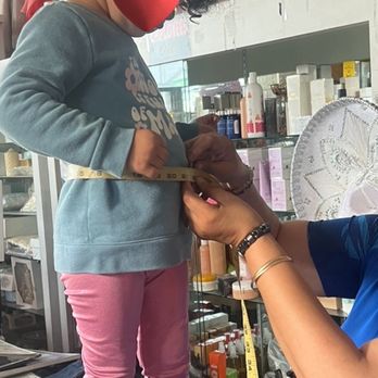 Mary's Bridal Shop - Mary, gently taking our daughter's measurements - Bridal Near Me - Montebello, California Mary's Bridal Shop - Mary, gently taking our daughter's measurements - Bridal Near Me - Montebello, California