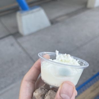 Pita Bistro - a hand holding a cup of ice cream - Mediterranean Near Me - Phoenix, Arizona