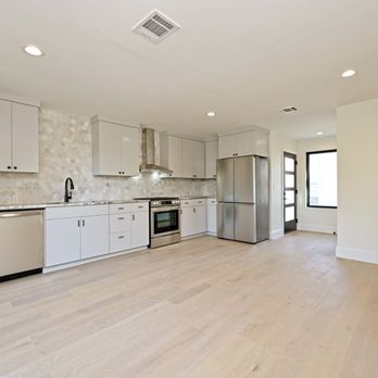 Pink Cube Development - Far out shot of modern kitchen remodel with hexagon tile backsplash and stainless appliances - General Contractors Near Me Pink Cube Development - Far out shot of modern kitchen remodel with hexagon tile backsplash and stainless appliances - General Contractors Near Me