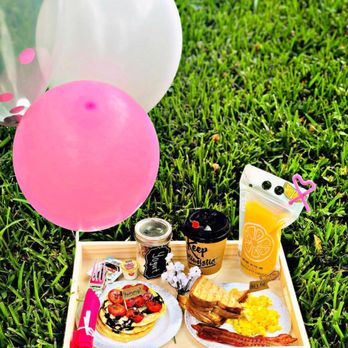 Surprise2go - a tray of breakfast items on the grass - Food Delivery Services Near Me
