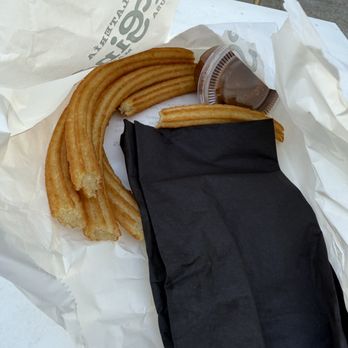 San Gines - This is the photo of $18 dolar cold churros in a bag with no attention to the guess like is a dog tha was going to eat it - Cafes Near Me - Austin, Texas San Gines - This is the photo of $18 dolar cold churros in a bag with no attention to the guess like is a dog tha was going to eat it - Cafes Near Me - Austin, Texas