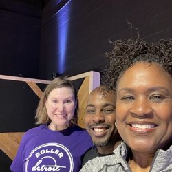 Roller Skate Detroit - Me showing off my purple T-shirt. My instructor, (also the owner) Keith in the middle, and my classmate Sandra.