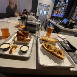 Blood orange two chili dogs one with raw onion and the other with crispy onion straws... Nashville hot wings