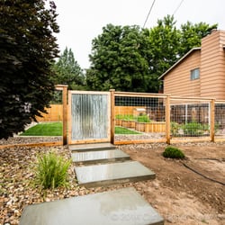 IS Fence - Garden fence with corrugated galvanized metal gate and wire picture-framed panels.