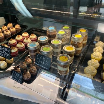 Champagne Cakery - a variety of cupcakes in a display case - Cupcakes Near Me - Livingston, Texas