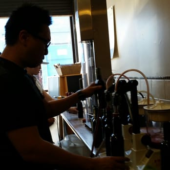 Grapes 2 Wine - a man pouring wine into a glass - Wineries Near Me - Richmond, British Columbia
