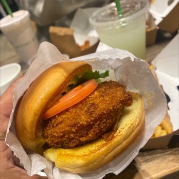 Shake Shack - a hand holding a chicken sandwich - Burgers Near Me - Los Angeles, California Shake Shack - a hand holding a chicken sandwich - Burgers Near Me - Los Angeles, California
