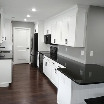 Kitchens Unlimited - a kitchen with white cabinets and black countertops - Cabinetry Near Me - Scott Depot, West Virginia Kitchens Unlimited - a kitchen with white cabinets and black countertops - Cabinetry Near Me - Scott Depot, West Virginia