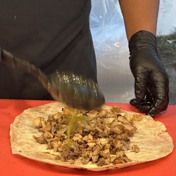 Angel’s Tijuana Tacos - a person in black gloves making a taco - Tacos Near Me - Long Beach, California Angel’s Tijuana Tacos - a person in black gloves making a taco - Tacos Near Me - Long Beach, California