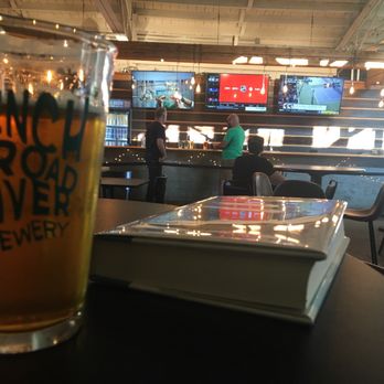 French Broad River Brewery - View of the taproom while I enjoy a book and a brew. - Breweries Near Me - Asheville, North Carolina French Broad River Brewery - View of the taproom while I enjoy a book and a brew. - Breweries Near Me - Asheville, North Carolina
