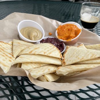 Wild Blue Yonder Brewing - Some pita bread Coconut oatmeal cream stout in the back - Brewpubs Near Me - Castle Rock, Colorado Wild Blue Yonder Brewing - Some pita bread Coconut oatmeal cream stout in the back - Brewpubs Near Me - Castle Rock, Colorado