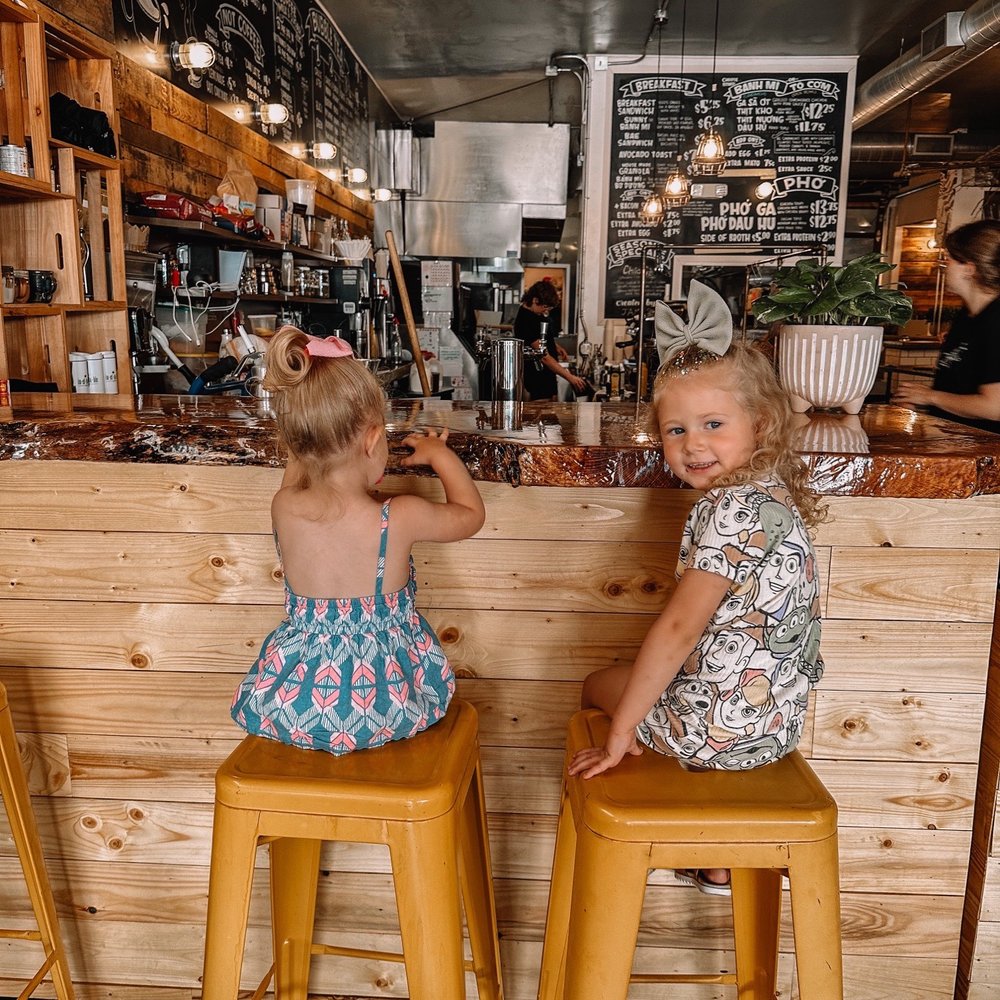 Ineffable Ca Phe - two little girls sitting on stools in a cafe - Vietnamese Near Me - Pittsburgh, Pennsylvania