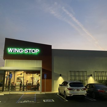 Wingstop - a parking lot with cars parked in front of it - Chicken Wings Near Me - Grand Terrace, California Wingstop - a parking lot with cars parked in front of it - Chicken Wings Near Me - Grand Terrace, California