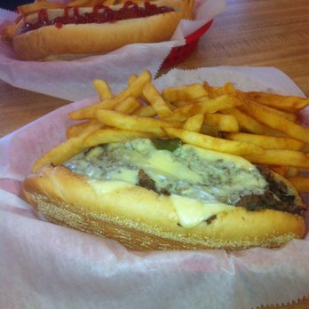 D'michaels - The Bomb: Conecuh sausage with a little Philly cheesesteak on top. My wife's ketchup only hot dog in the background. - Sandwiches Near Me - Theodore, Alabama D'michaels - The Bomb: Conecuh sausage with a little Philly cheesesteak on top. My wife's ketchup only hot dog in the background. - Sandwiches Near Me - Theodore, Alabama