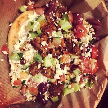 CAVA - Mini pita with harissa honey chicken, olives, cucumber and tomato salad, couscous and tzatiki sauce. - Mediterranean Near Me - Plano, Texas