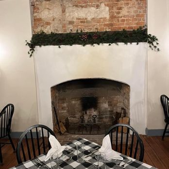 1710 Tavern - a table setting with a fireplace in the background - Wine Bars Near Me - Tappahannock, Virginia