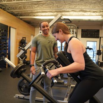 Austin Simply Fit - Our personal trainer coaching a client through a seated row. - Gyms Near Me - Austin, Texas Austin Simply Fit - Our personal trainer coaching a client through a seated row. - Gyms Near Me - Austin, Texas