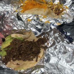 Taqueria Fernandez - Bacon, egg, and cheese taco on flour Beef fajita taco with avocado on flour
