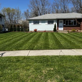 Khan Enterprises - a freshly mowed lawn in front of a house - Lawn Services Near Me Khan Enterprises - a freshly mowed lawn in front of a house - Lawn Services Near Me