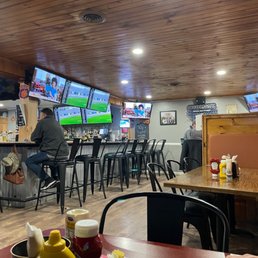 people sitting at the bar watching tvs people sitting at the bar watching tvs