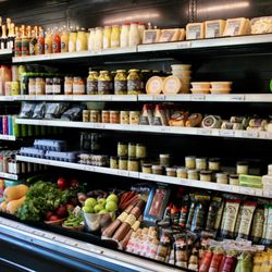 Beradu Specialty Market Kitchen & Bar - Fridge section of our market stocked with locally sourced grocery items, organic produce, farm fresh eggs, quail eggs, wine & beer, and more