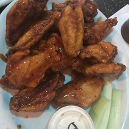 a plate of chicken wings and celery