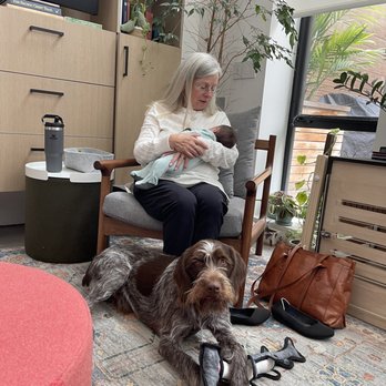 Roxane Thompson Doula - Roxane with our baby and doggie (who adores her!) at her feet. - Doulas Near Me - San Francisco, California Roxane Thompson Doula - Roxane with our baby and doggie (who adores her!) at her feet. - Doulas Near Me - San Francisco, California