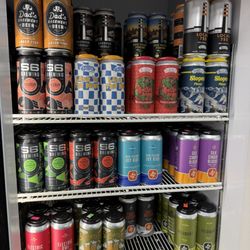Princeton's Liquors Bass Lake - A dense, colorful, multi-shelf interior view of a single commercial reach-in refrigerated cooler door, packed entirely with c...