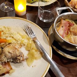 Le Volant Basque - Rabbit stew. Some of the rice and polenta on the plate. Bowls of rice, polenta, mashed potatoes just out of frame on the right.