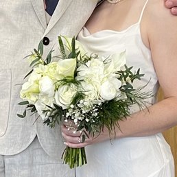 A bouquet of white flowers and greenery. A bouquet of white flowers and greenery.