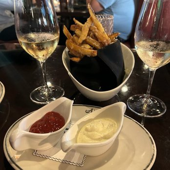 A Crystal Cove - Truffle Fries ($16, June 2026) with Ketchup and Truffle Aioli.   Left Glass is Diatom, Right is Pierre Riffault Sancerre - New American Near Me - Newport Beach, California